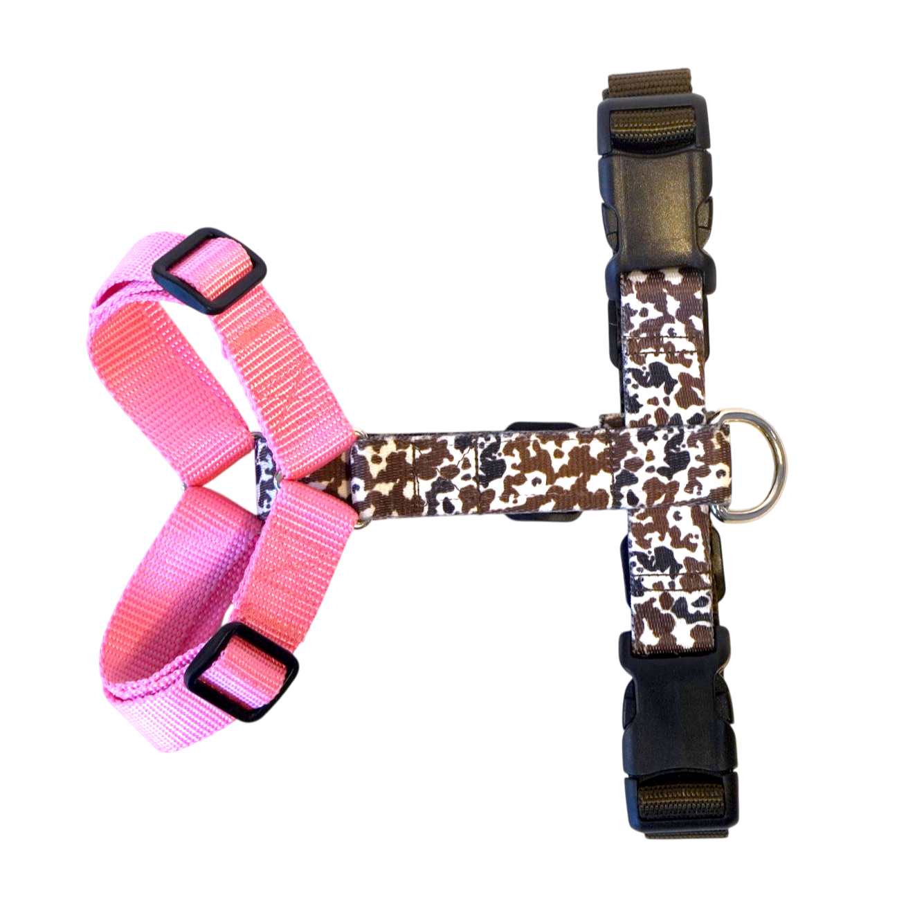 A Y-shape anatomical  dog harness with a pink left side and cow patterned right side, featuring black plastic buckles and a silver metal ring.