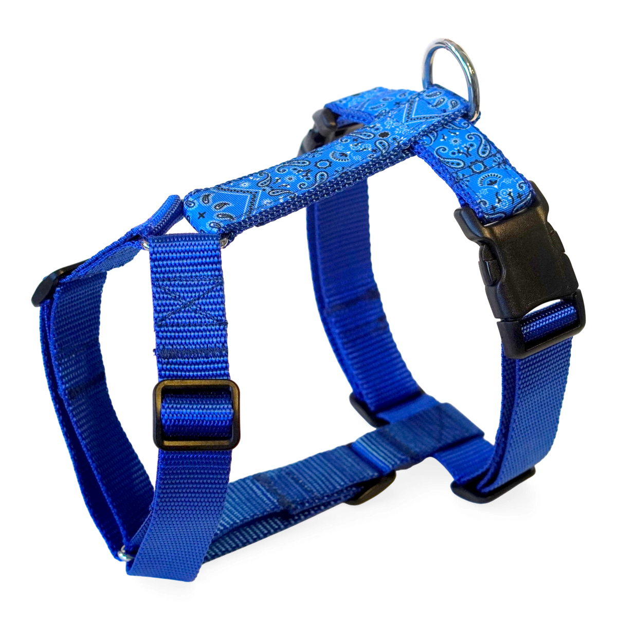 Blue paisley patterned dog harness with black plastic buckles and a metal ring, shown on a white background.